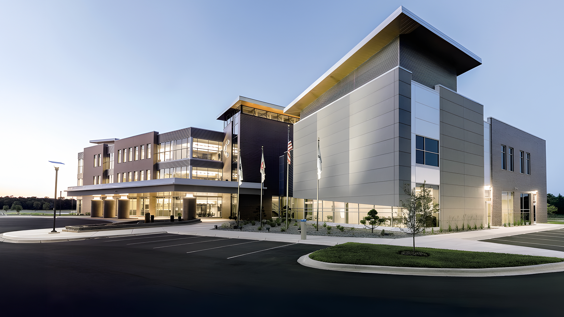 Modern commercial office building with architectural metal panels and glass, constructed using Butler pre-engineered and conventional steel building systems.